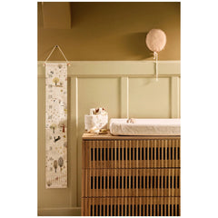 Jollein pacifier cloth Mick on a wooden dresser, featuring white patterned fabric and a hanging matte plastic balloon.