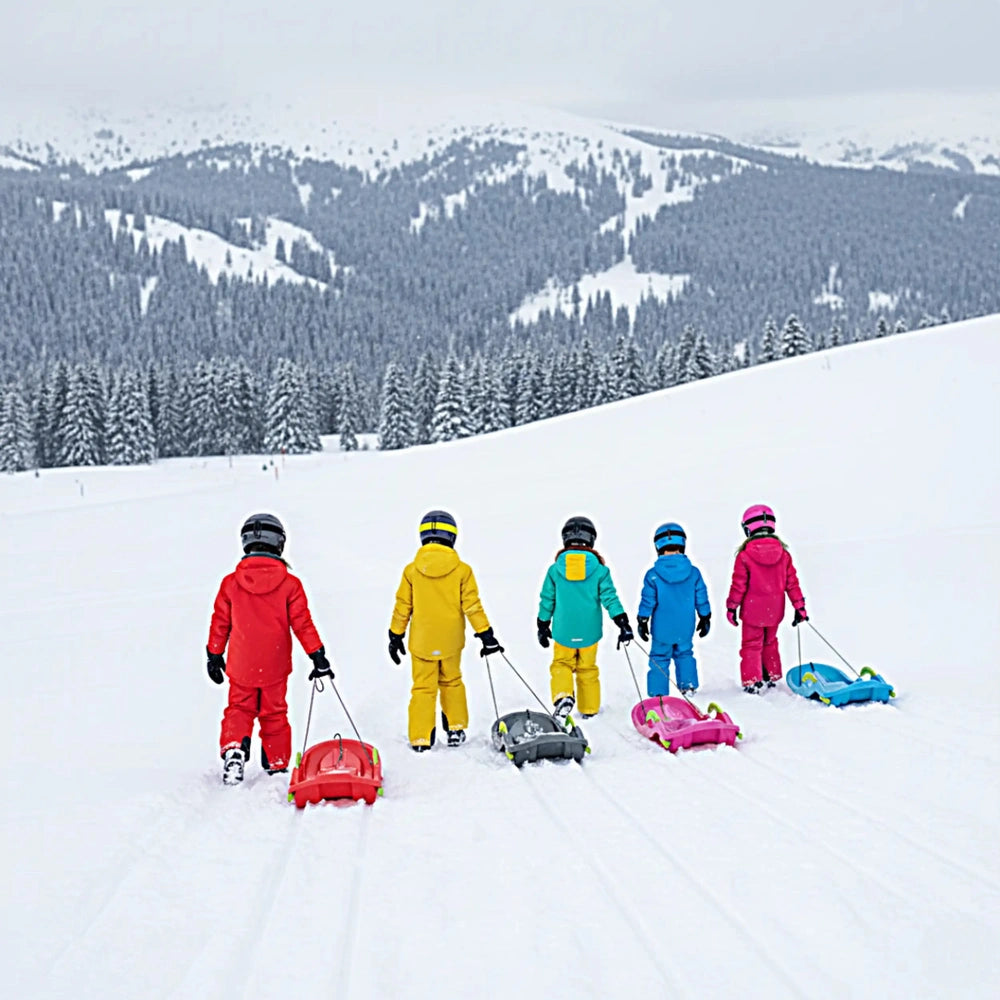 KHW Snow Fox Sleds in vibrant colors with five children in snowsuits playing on fresh snow in a snowy landscape.