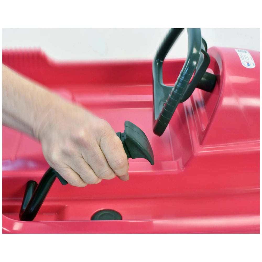 KHW Snow Fox Sled in anthracite features a black handle and steering wheel, with a red car seat, designed for outdoor play.
