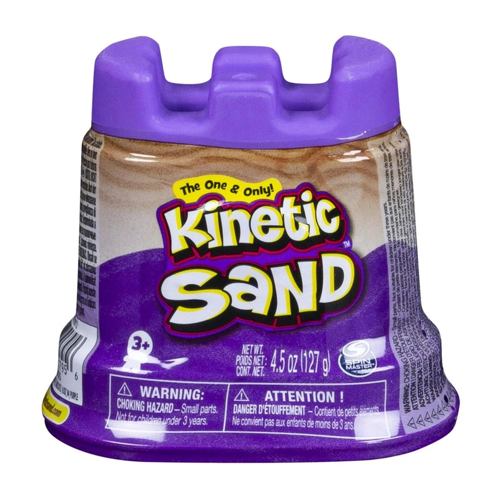 Kinetic Sand container with a purple body and brownish-beige base, featuring a playful label and warning text, against a whit