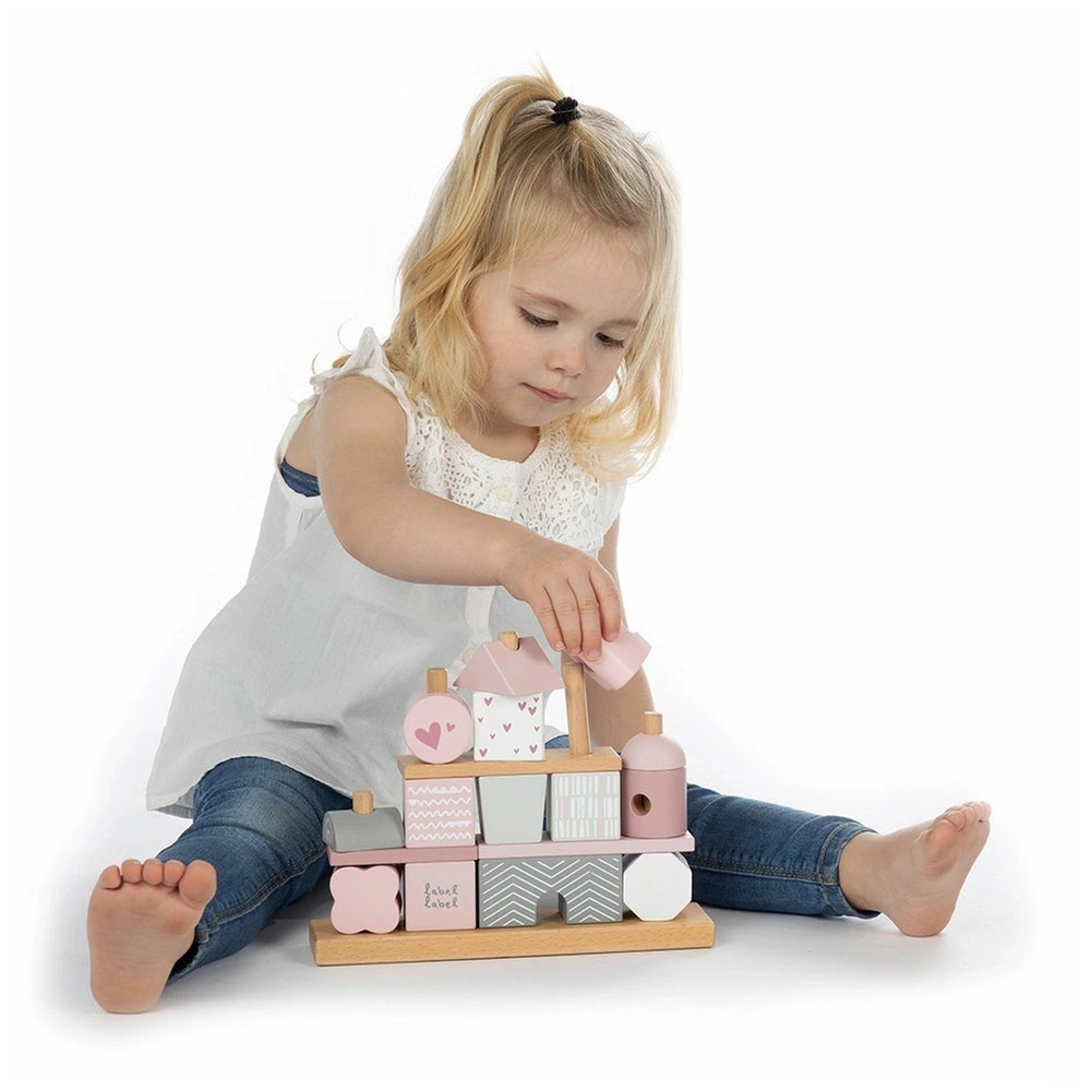 Label-Label stacking blocks house with a young girl in a white dress, featuring pink, gray, and white plastic components.