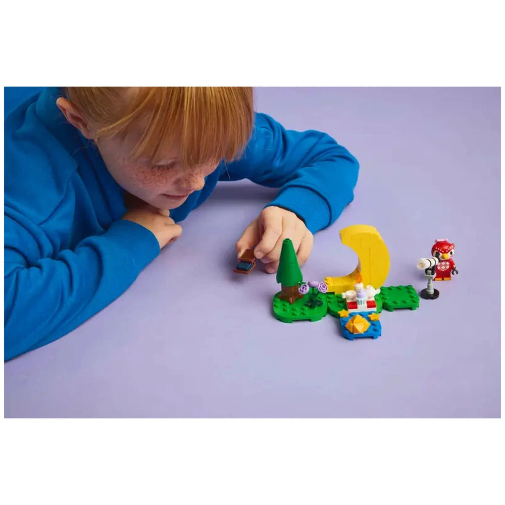 Lego - Animal Crossing - Stargazing with Celeste set displayed as a child with red hair engages with colorful small toys on a
