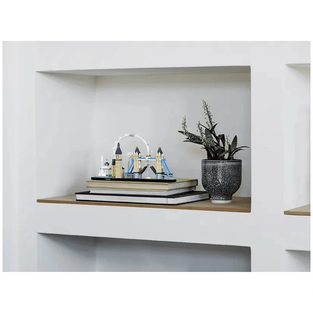 Lego Architecture London construction set displayed on a white shelf alongside books and a succulent plant.