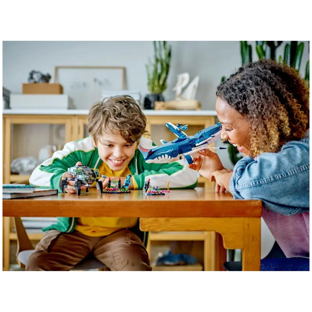 Two children engage in imaginative play with LEGO® Avatar sets on a wooden table, showcasing colorful underwater-themed toys.