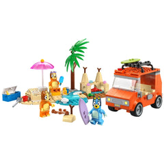 Colorful LEGO beach scene featuring Bluey and Bingo with a family car, palm trees, a pink umbrella, and surfboards, all set for a fun beach adventure.
