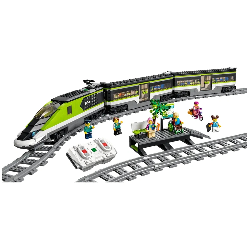 LEGO City Express Passenger Train set with a sleek green and gray locomotive, two minifigures, remote controls, and a waiting area with a tree.