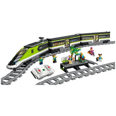 LEGO City Express Passenger Train set with a sleek green and gray locomotive, two minifigures, remote controls, and a waiting area with a tree.