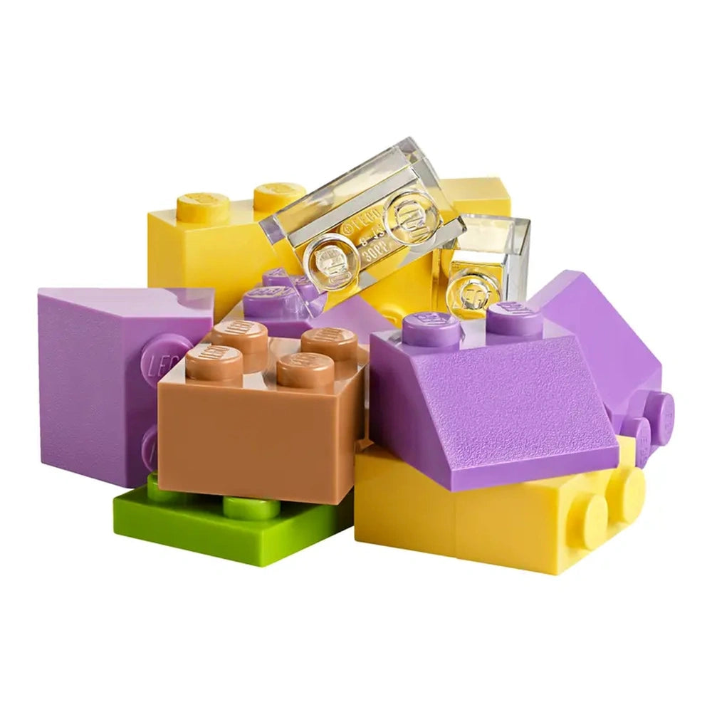 Colorful LEGO bricks in various shapes, including yellow, brown, purple, and green, stacked together in a playful arrangement.