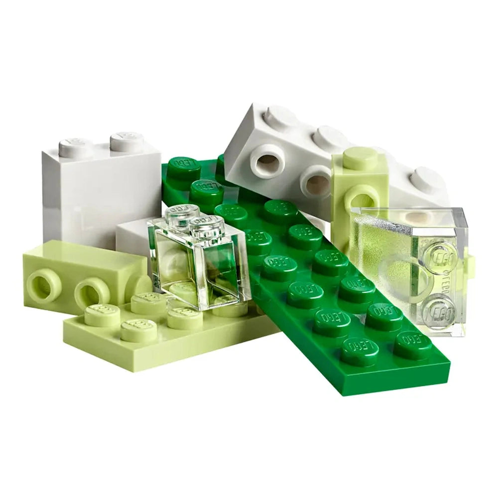 A variety of LEGO bricks in shades of green, white, and translucent, featuring a mixture of rectangular and square shapes, arranged haphazardly.