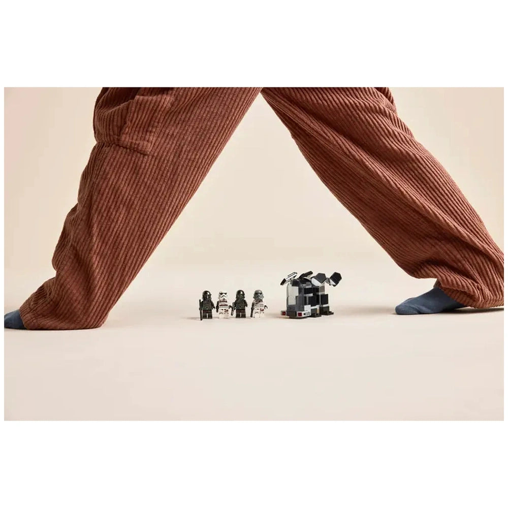 LEGO Death Trooper and Night Trooper figures stand in front of a dropship, with a person’s brown corduroy pants and blue sock visible in the background.