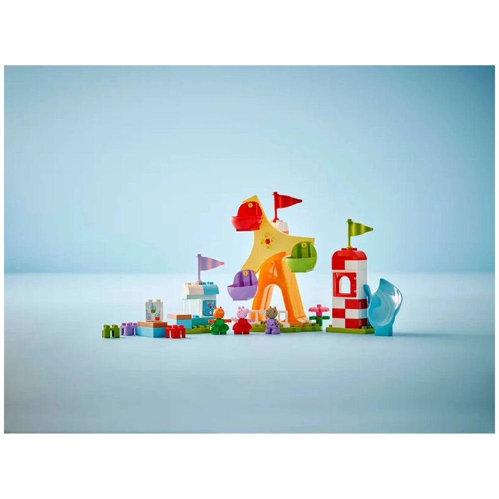 Colorful LEGO® DUPLO® Peppa Pig Funfair set featuring a star-shaped ride with flags, a Ferris wheel, and playful figures.