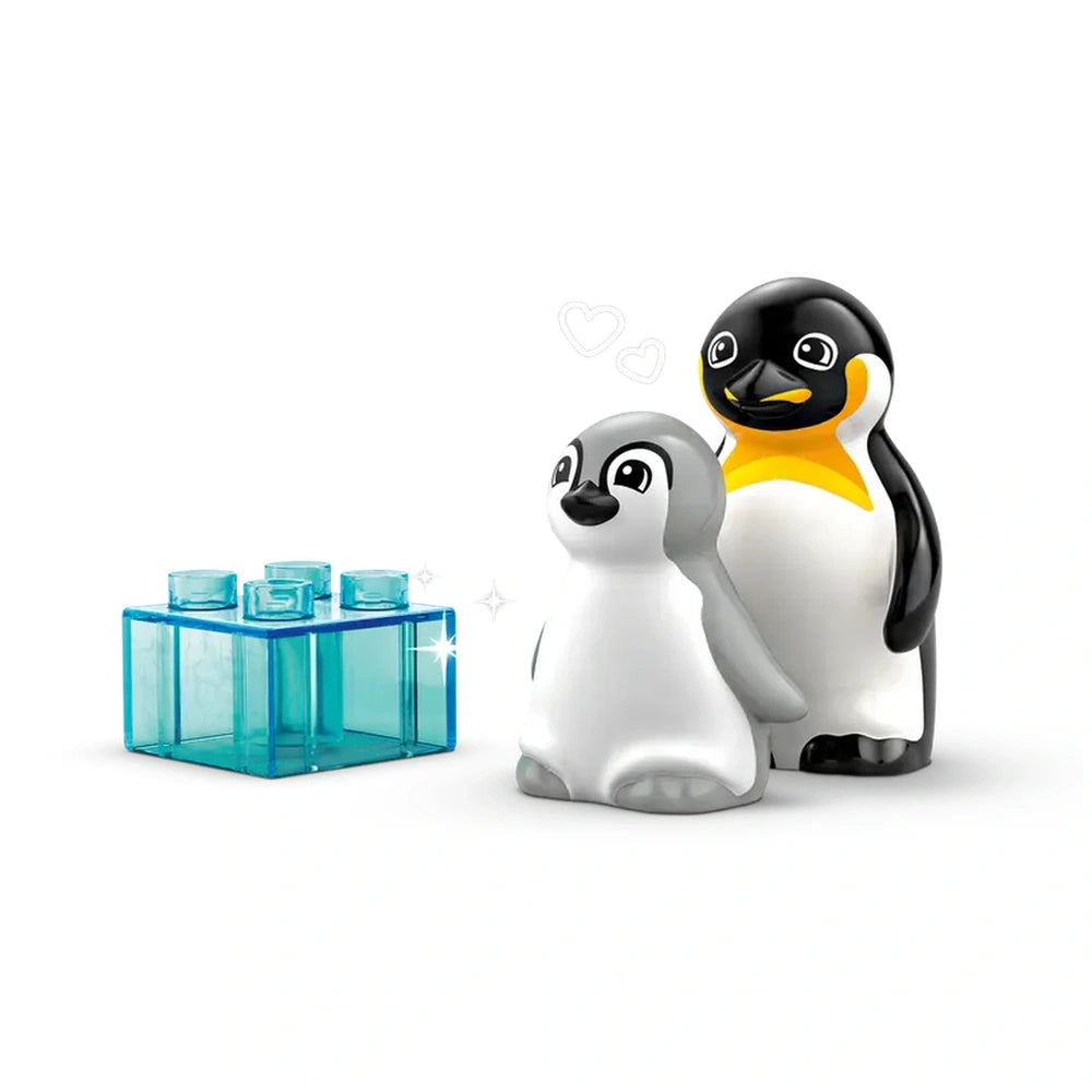 Two colorful LEGO® DUPLO® penguin figures, one larger with a yellow chest and one smaller, stand next to a transparent blue building block.