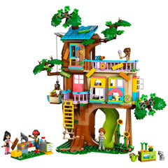 Colorful LEGO Friends tree house set featuring intricate details, playful minidolls, and playful animal figures, surrounded by greenery.