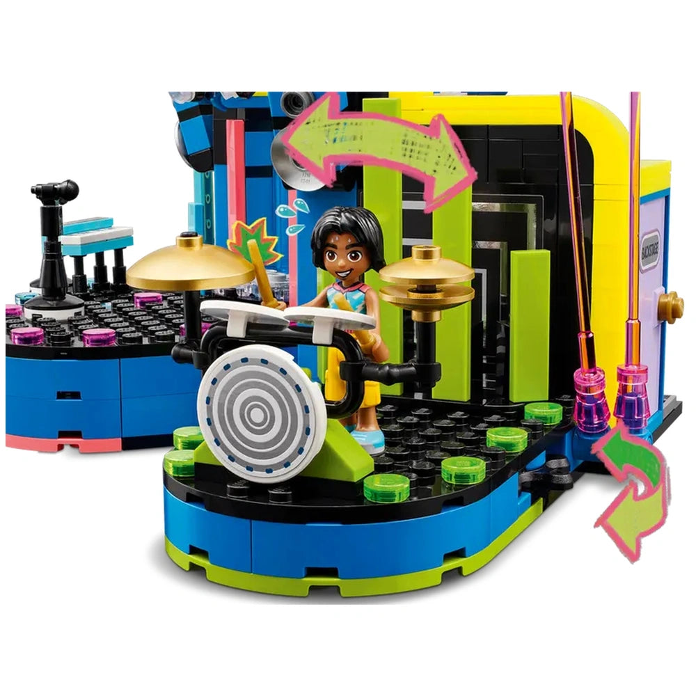 A colorful LEGO construction set featuring a smiling girl playing drums on a vibrant music stage with bright green and blue elements.