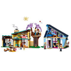 Two colorful LEGO houses with intricate details, accompanied by five mini-dolls, a micro-doll, and pets. A tree house connects the two homes, showcasing vibrant scenes of friendship and play.