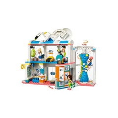 LEGO® Friends Sports Center playset featuring four mini-dolls engaged in various sports activities, with a vibrant construction including a climbing wall, sports equipment, and accessories for soccer, tennis, and basketball.