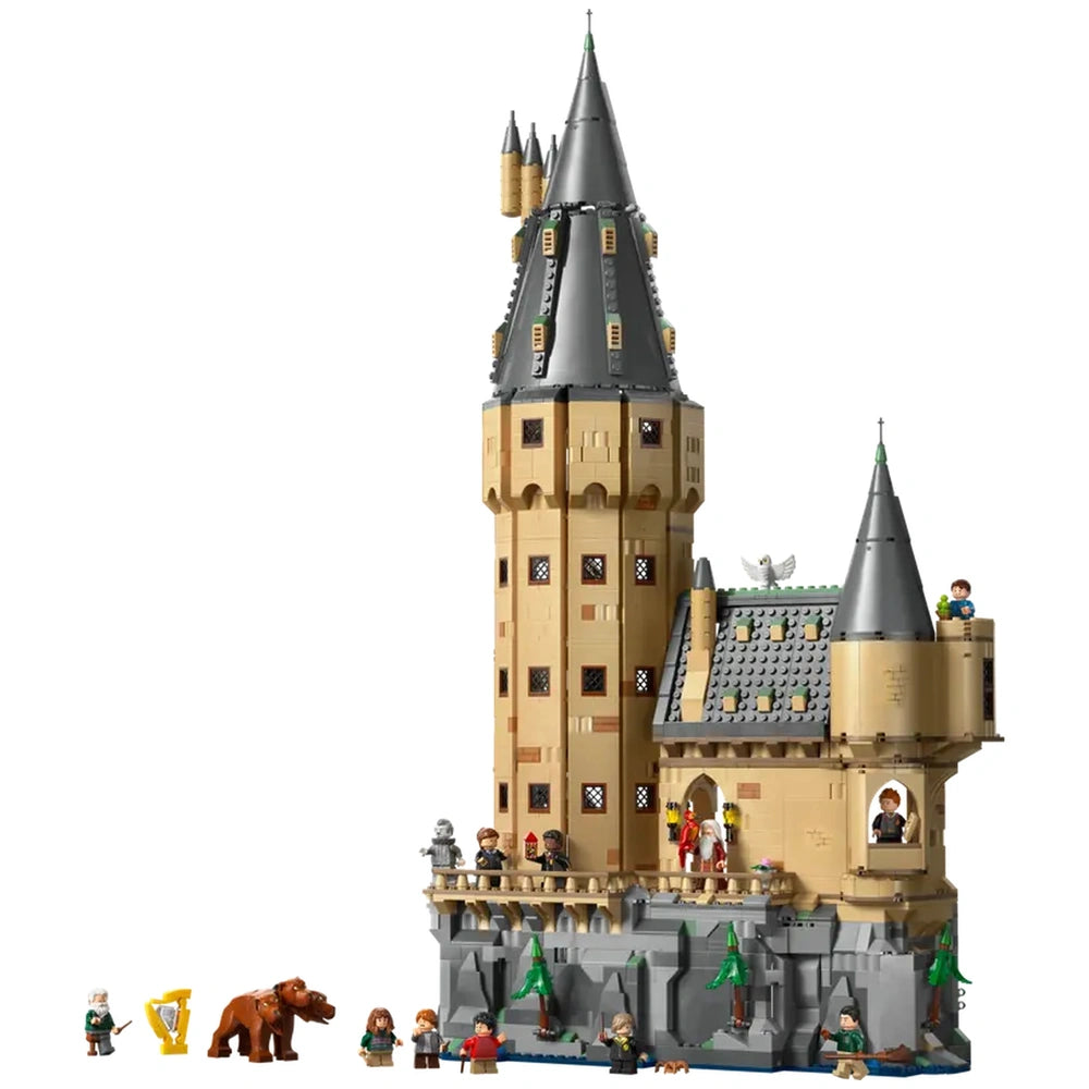 LEGO Harry Potter Hogwarts Castle set features a tall, tan tower with gray rooftops, surrounded by colorful minifigures and a bear.
