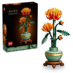 LEGO® Icons Chrysanthemum Construction Set featuring an orange chrysanthemum in full bloom, with buds and vibrant green leaves, planted in a pastel green pot with a golden band.