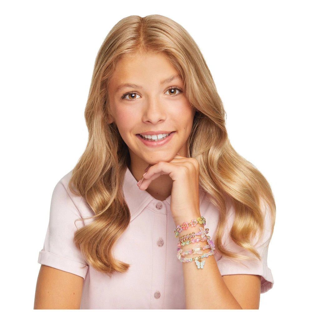 Butterfly Jewelry Set showcased by a young girl with blonde hair wearing a pink shirt and colorful patterned bracelets.