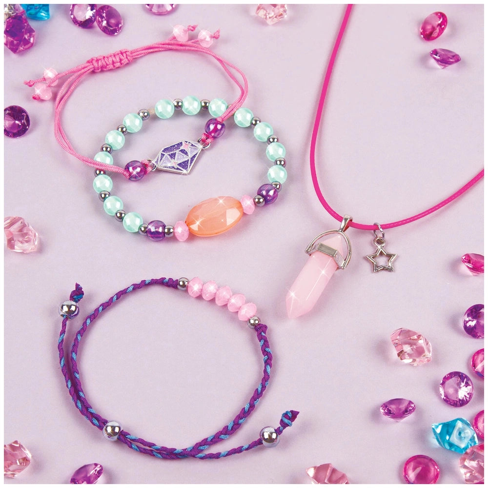Positive Gems Jewelry bracelet featuring a pink elastic band and various translucent beads in blue, green, pink, orange, and 
