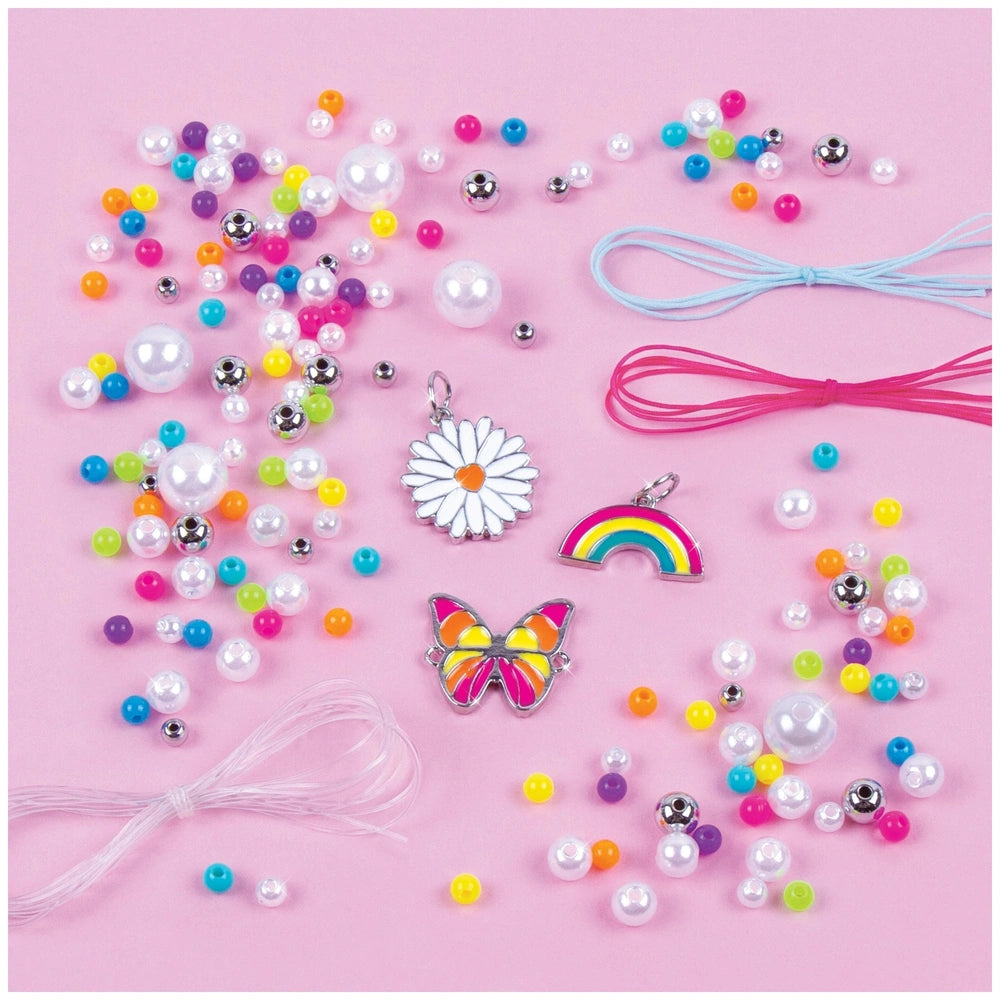 Rainbow Treasure Bracelets featuring vibrant plastic and metal beads, pink ribbon, and assorted metal charms in a close-up vi