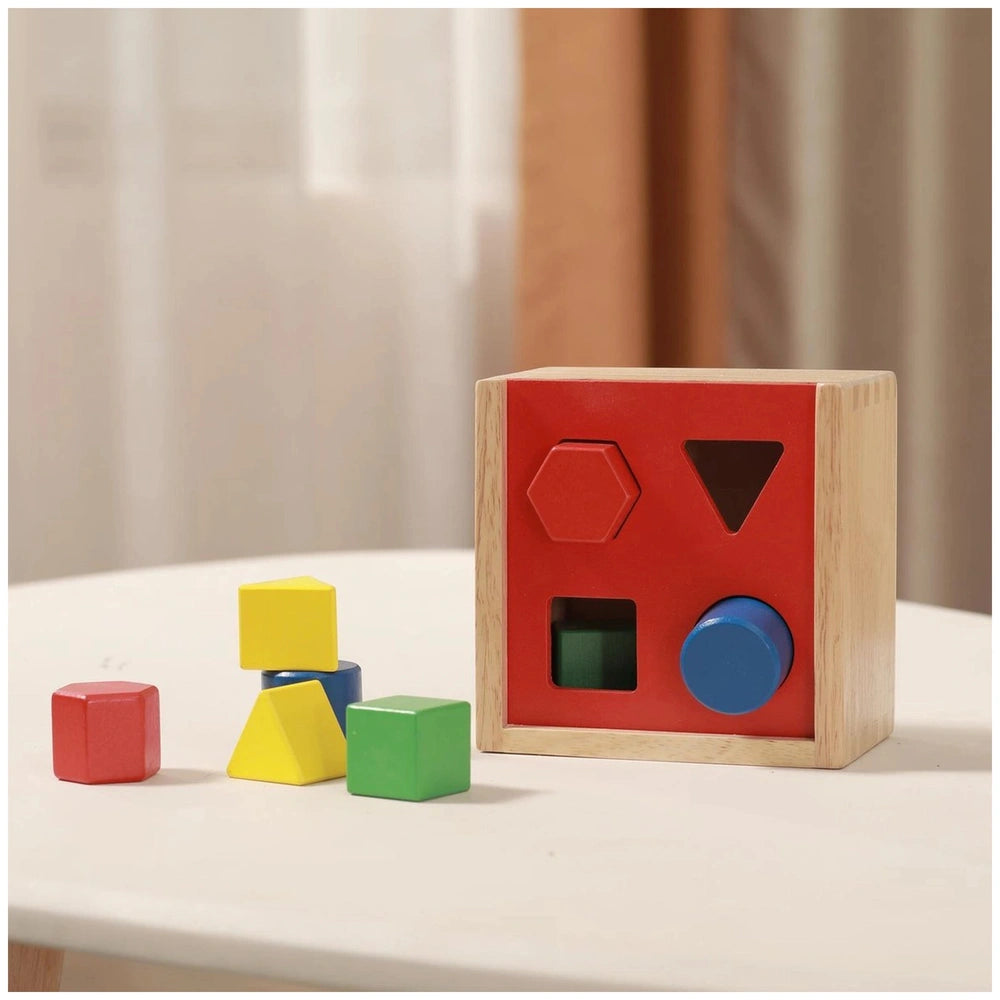 Colorful shape sorter with red wooden box and yellow, blue, green blocks for baby activity.