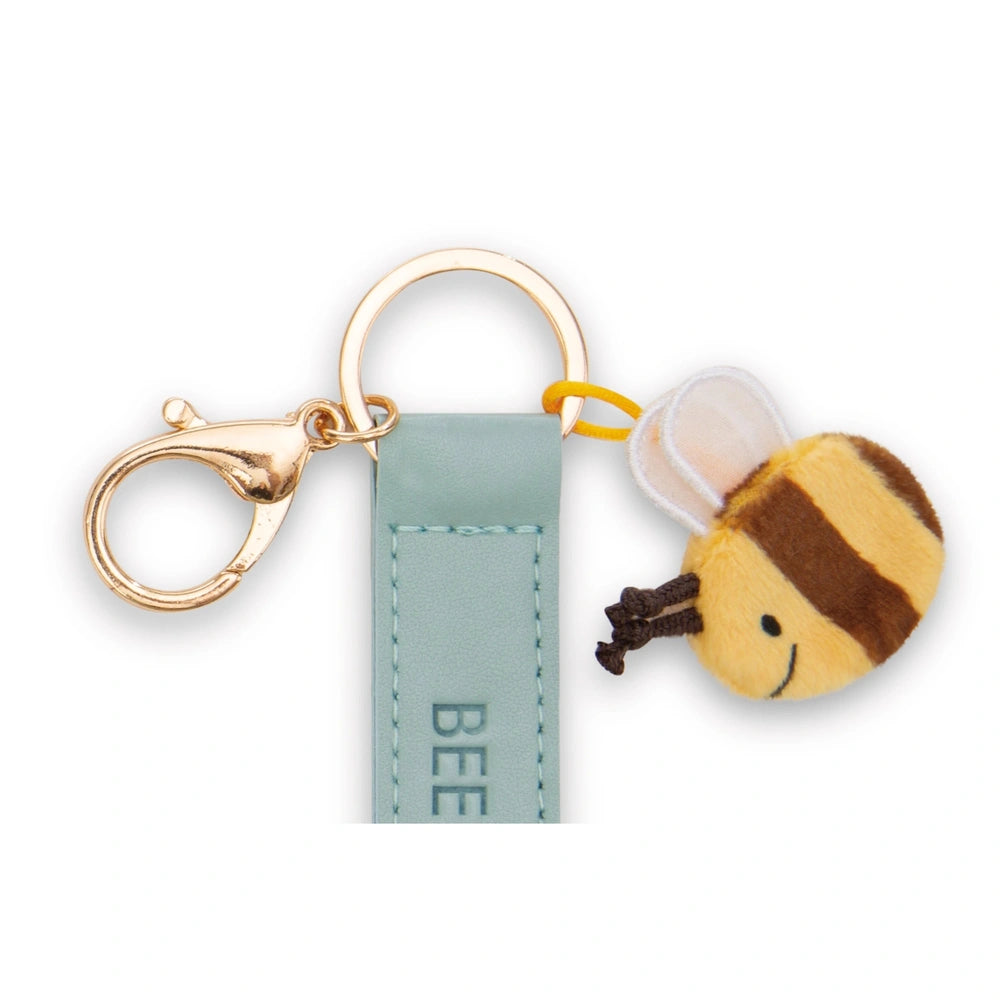 Bee Happy Keyholder features a gold metal keychain, teal tag with "BEE" in white, and a plush yellow bee charm.