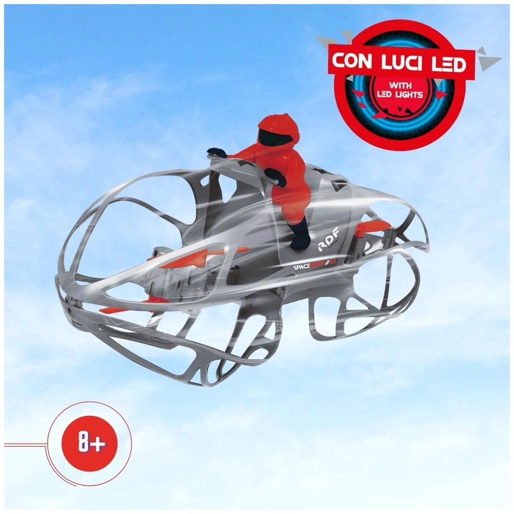 Radiofly Space Biker 25 drone with a person in a red suit and helmet on a transparent platform under a blue sky.