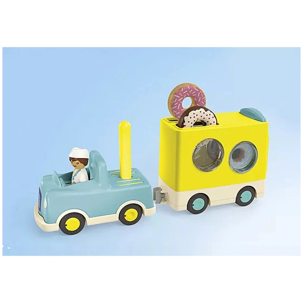 Playmobil Crazy-Donut-Truck features a yellow front, blue cab, white roof, and black wheels, all in a matte plastic finish.