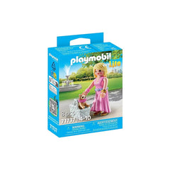 Playmobil It-Girl toy playset features a blonde doll in pink dress holding a purse, displayed in blue packaging with a QR cod