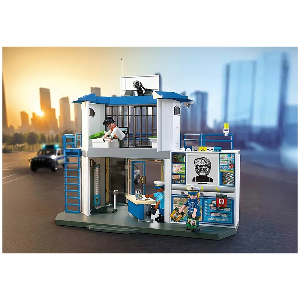 Playmobil Police Station with Investigation Room featuring blue roof, white walls, and plastic figures in blue attire holding