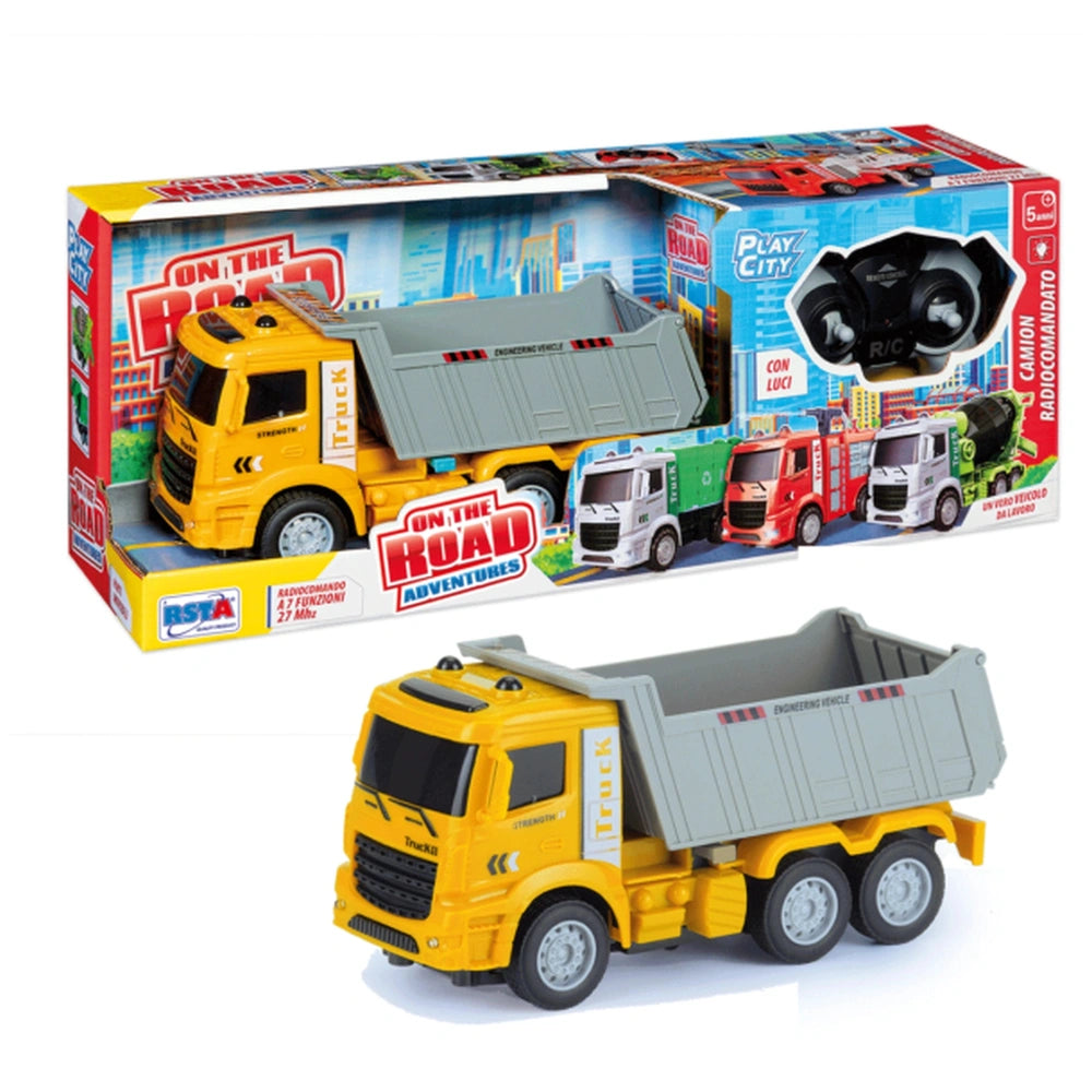 RS Toys On The Road Adventure RC Truck in a colorful box with a yellow and gray truck and a gray and yellow dump truck outsid