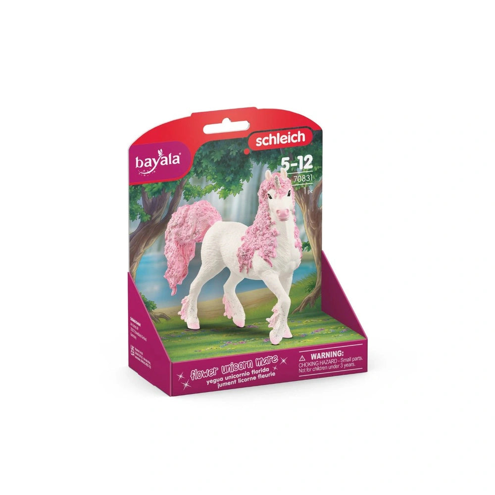 Flower unicorn toy in pink and white packaging with a clear window, set against a natural background of water and trees.