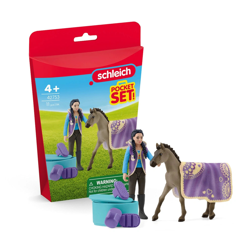 Schleich Beauty Set features a purple toy horse and a rider in blue and green, set against a vibrant red packaging.