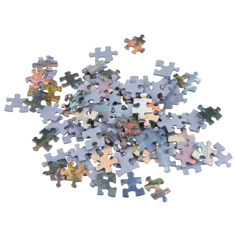 Schmidt Spiele Bambi puzzle pieces in various colors scattered on a plain background, showcasing their smooth, glossy finish.