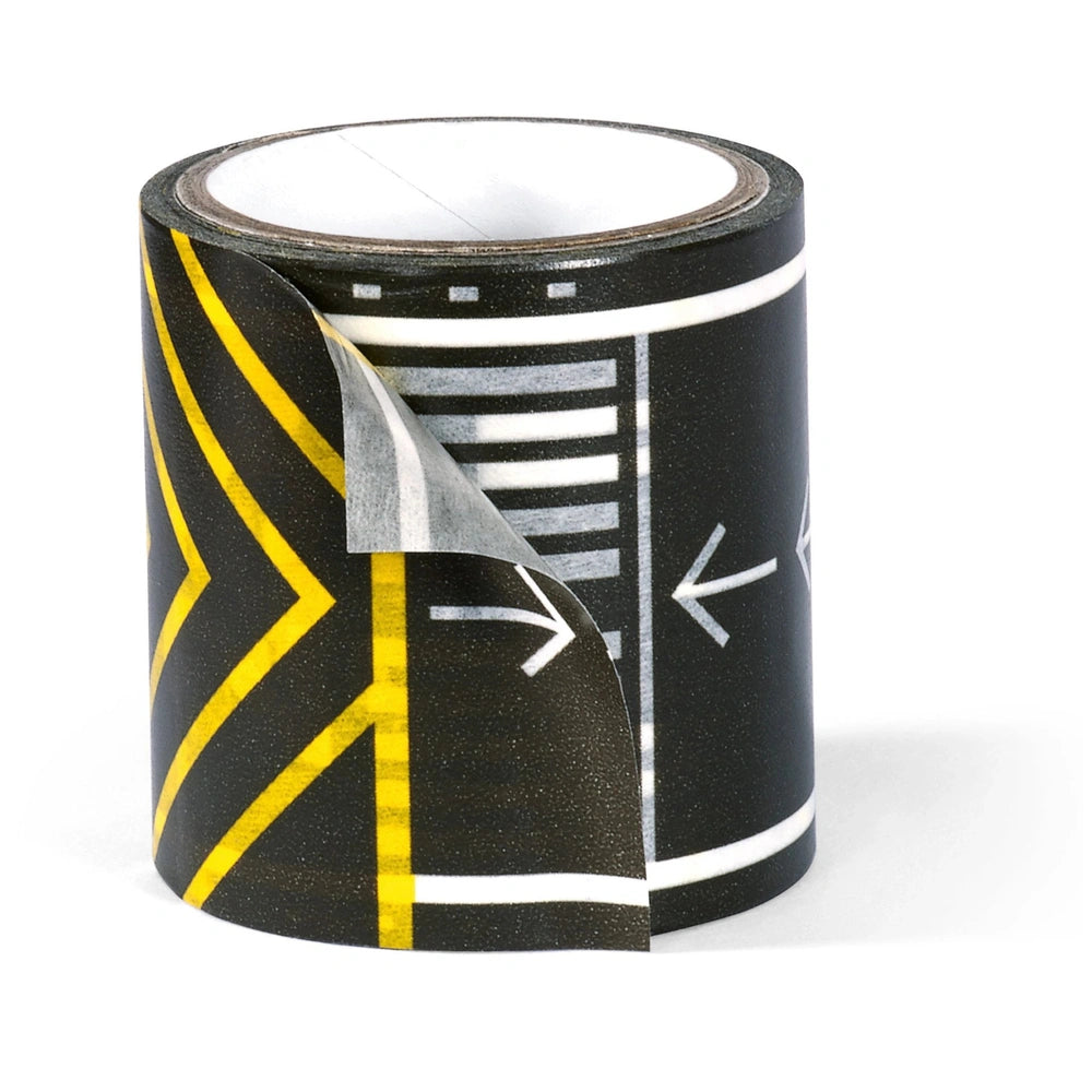 Siku Airport set features a roll of black tape with yellow and white stripes, partially unrolled on a flat surface.