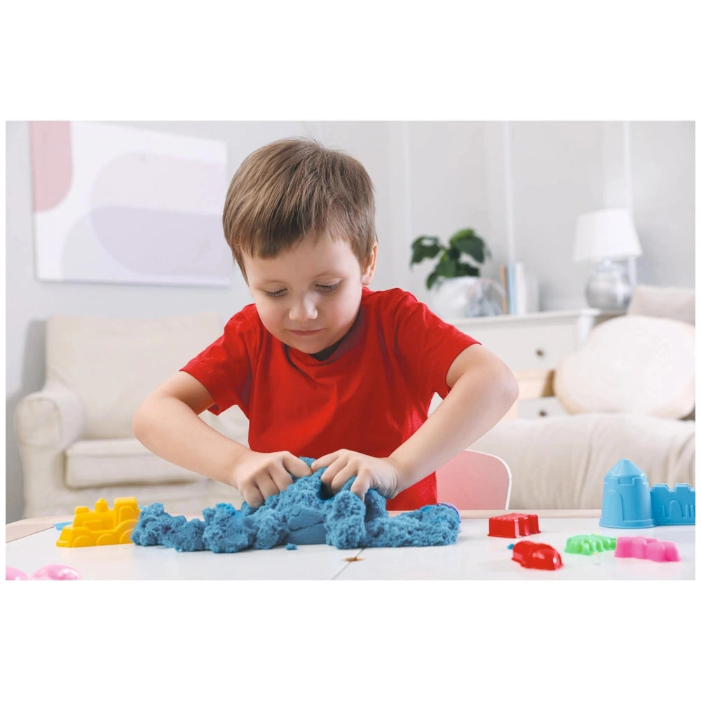 Simba Art & Fun Dinosaur Sand Set with colorful play dough; child happily molding blue clay at a bright, modern table.