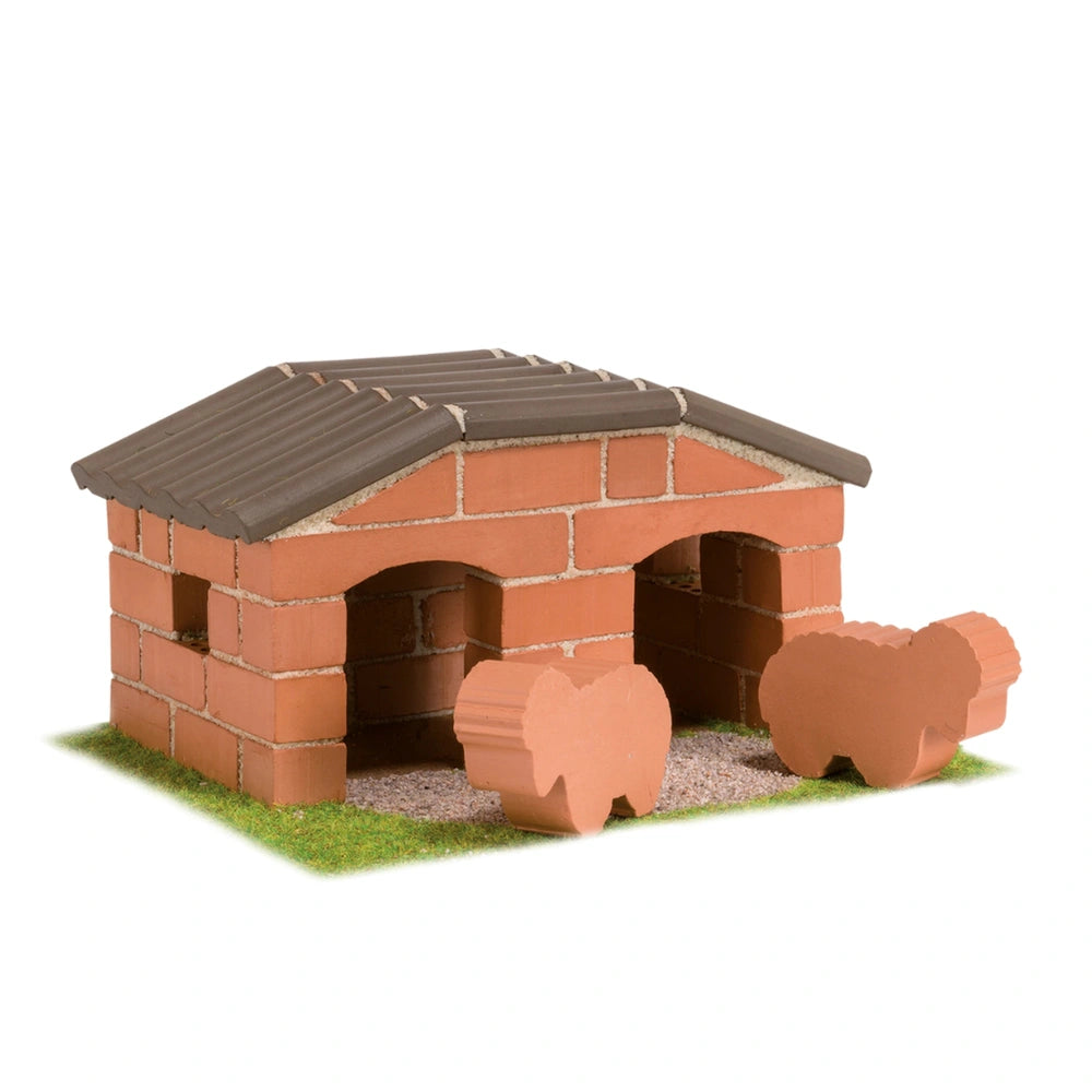 Teifoc sheepfold features a brick-built structure with a shingled roof on a grass-like base, creating a charming outdoor scen