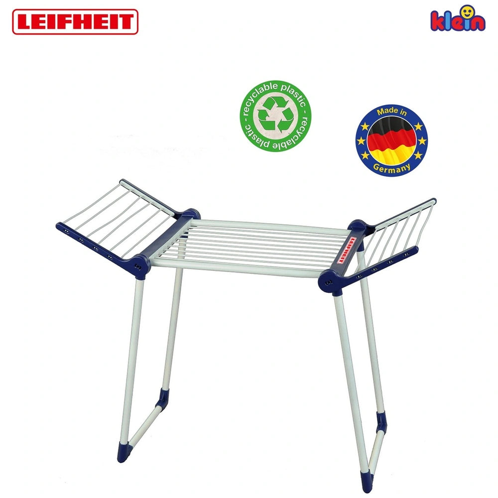 Theo Klein Leifheit drying rack features a silver metal frame, translucent grid-patterned tabletop, and colorful logos.